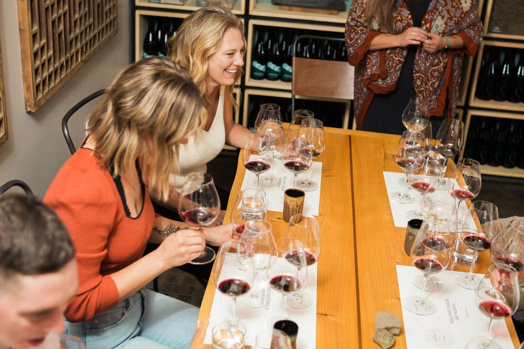 People tasting wine in the Ohana tasting room