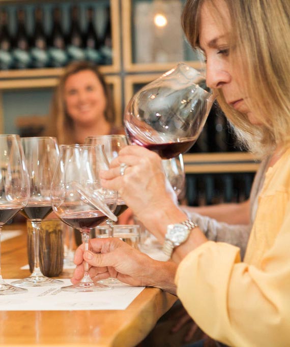 A woman tasting wine